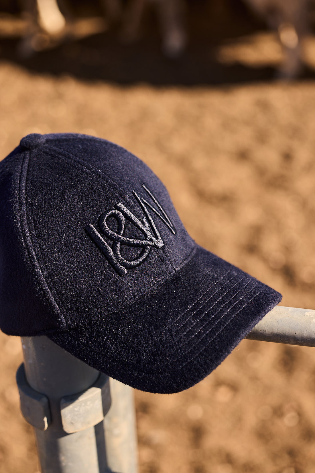 Close-up of a navy blue men’s wool cap showcasing fine knit texture and structured design for warmth and style.