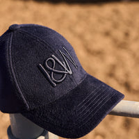 Close-up of a navy blue men’s wool cap showcasing fine knit texture and structured design for warmth and style.