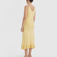 Elegant maize-colored wool dress with fluted hem design.