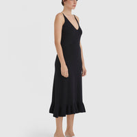 Elegant merino wool knit dress in black with frill hem details.