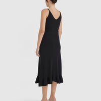 Classic black wool dress with fluted hem, perfect for evening wear.