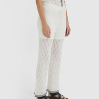 Elegant white lace pants with scalloped trims, ideal for versatile summer styling.