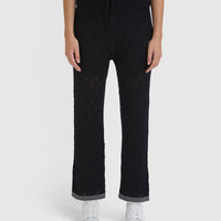 Close-up of Chiara black lace stitch pants with delicate lace details.
