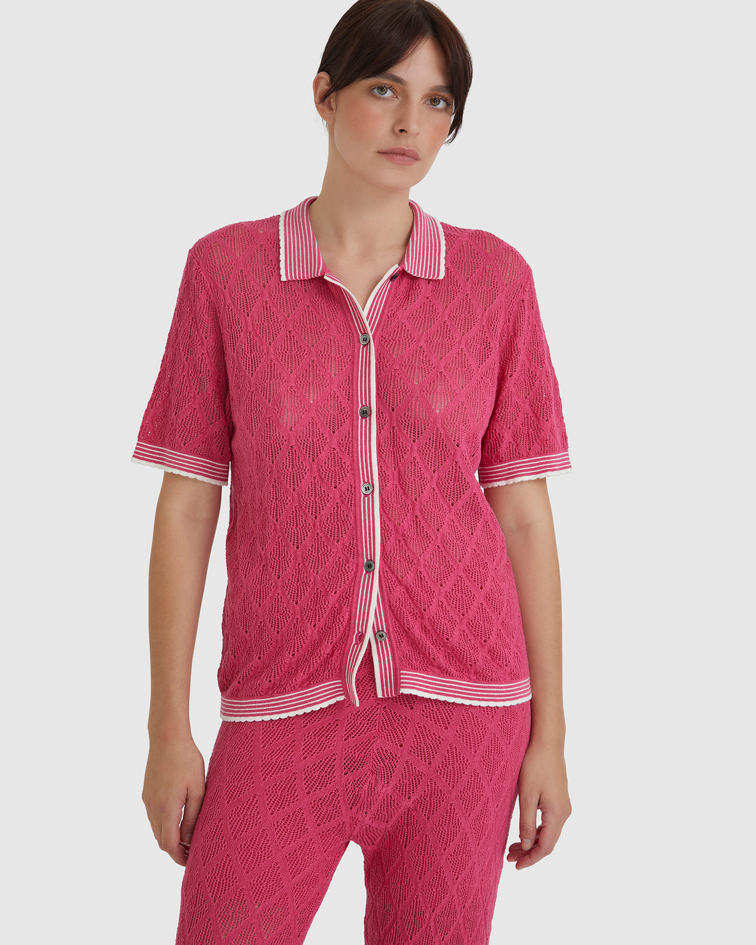 Chiara lace top in pomegranate with detailed lace stitching and scalloped edges.