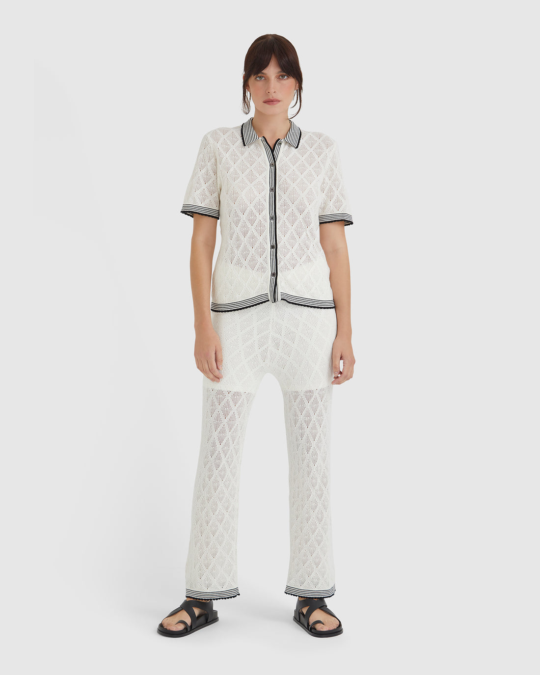 White lace pants in merino wool blend with scalloped edges and jersey waistband.