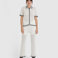 White lace pants in merino wool blend with scalloped edges and jersey waistband.