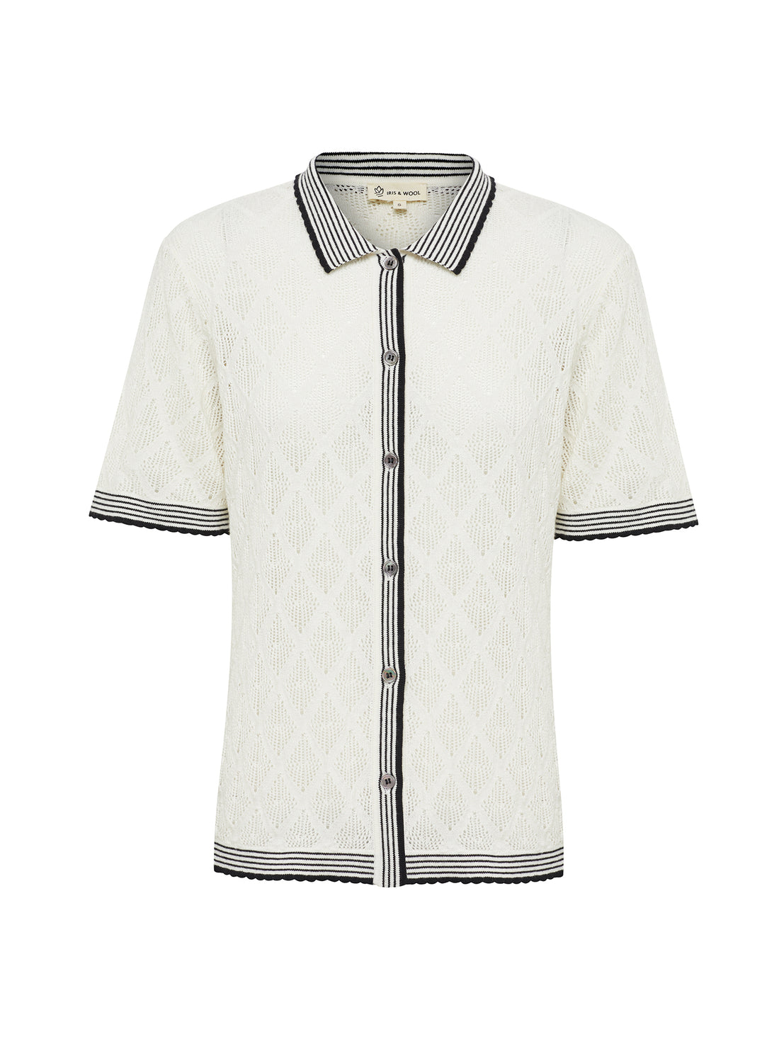 Close-up of intricate lace detail on Chiara lace top in white.