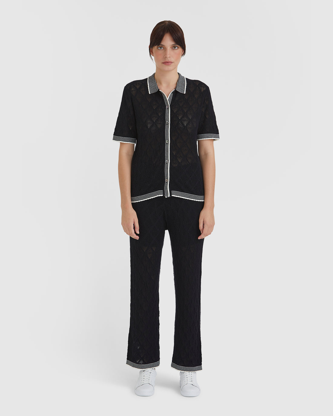 Black lace pants in merino wool blend with scalloped trims.