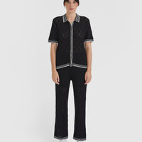 Black lace pants in merino wool blend with scalloped trims.