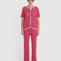 Elegant pomegranate lace top with mother-of-pearl buttons, ideal for versatile styling.