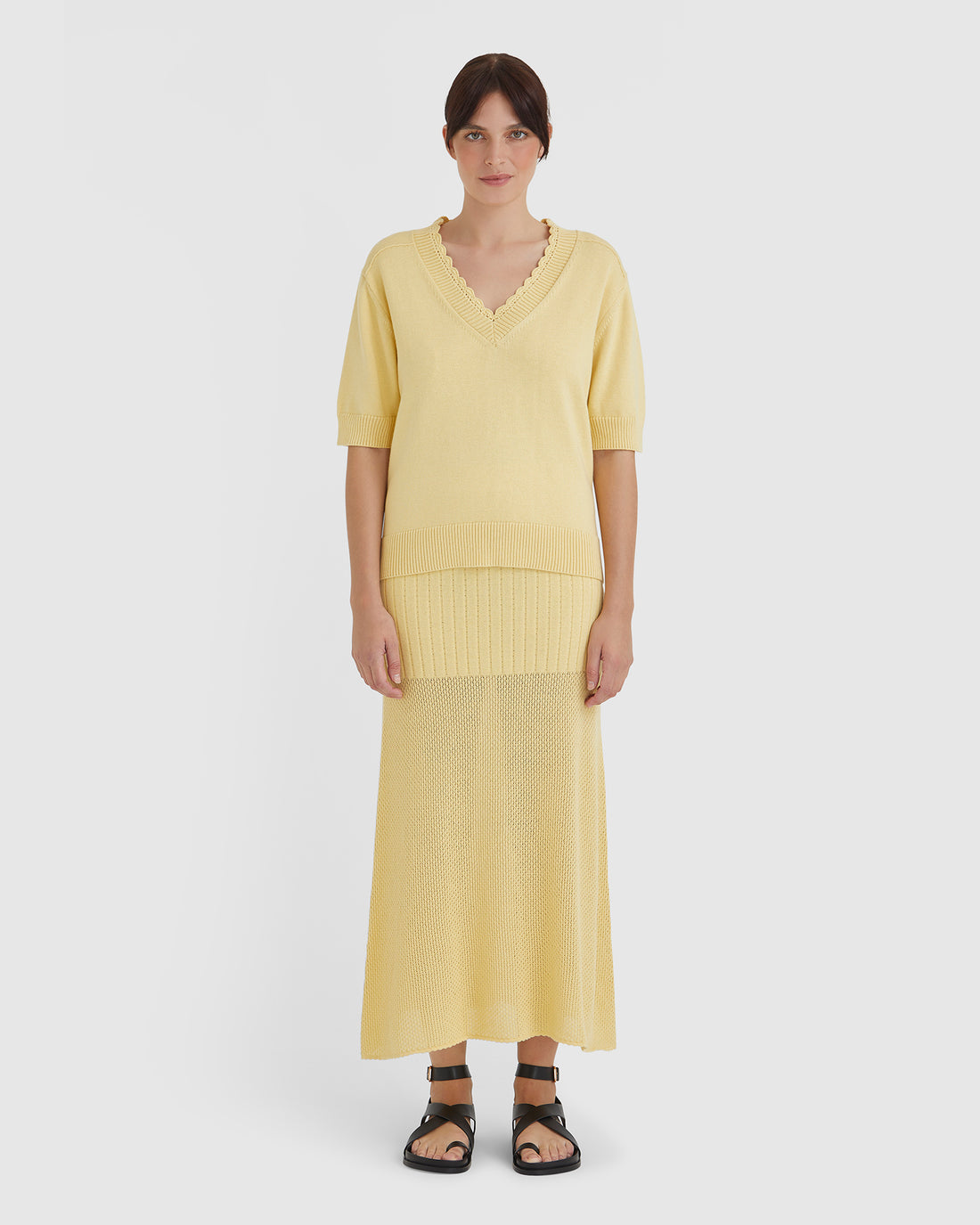 Elegant women’s knitwear top in maize with crochet edging and delicate pintucks.