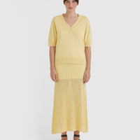 Elegant women’s knitwear top in maize with crochet edging and delicate pintucks.