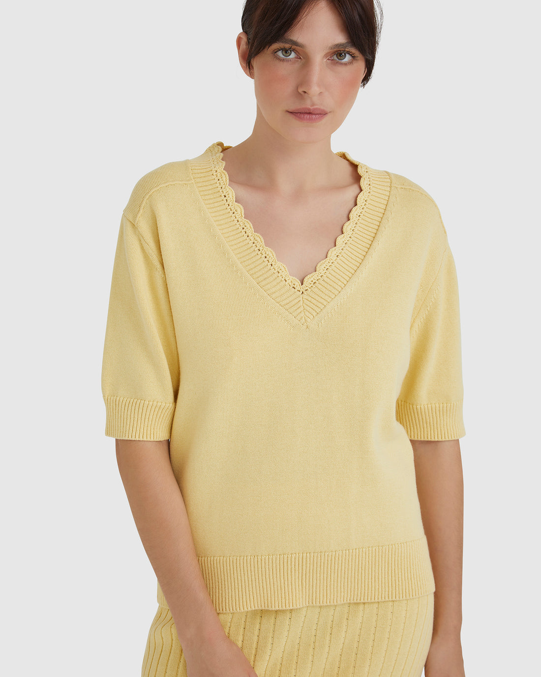 Elsa maize crochet top with V-neckline and hand-crocheted edging.