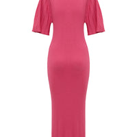 Back view of merino wool dress in pomegranate, designed with elegant pleated sleeves.