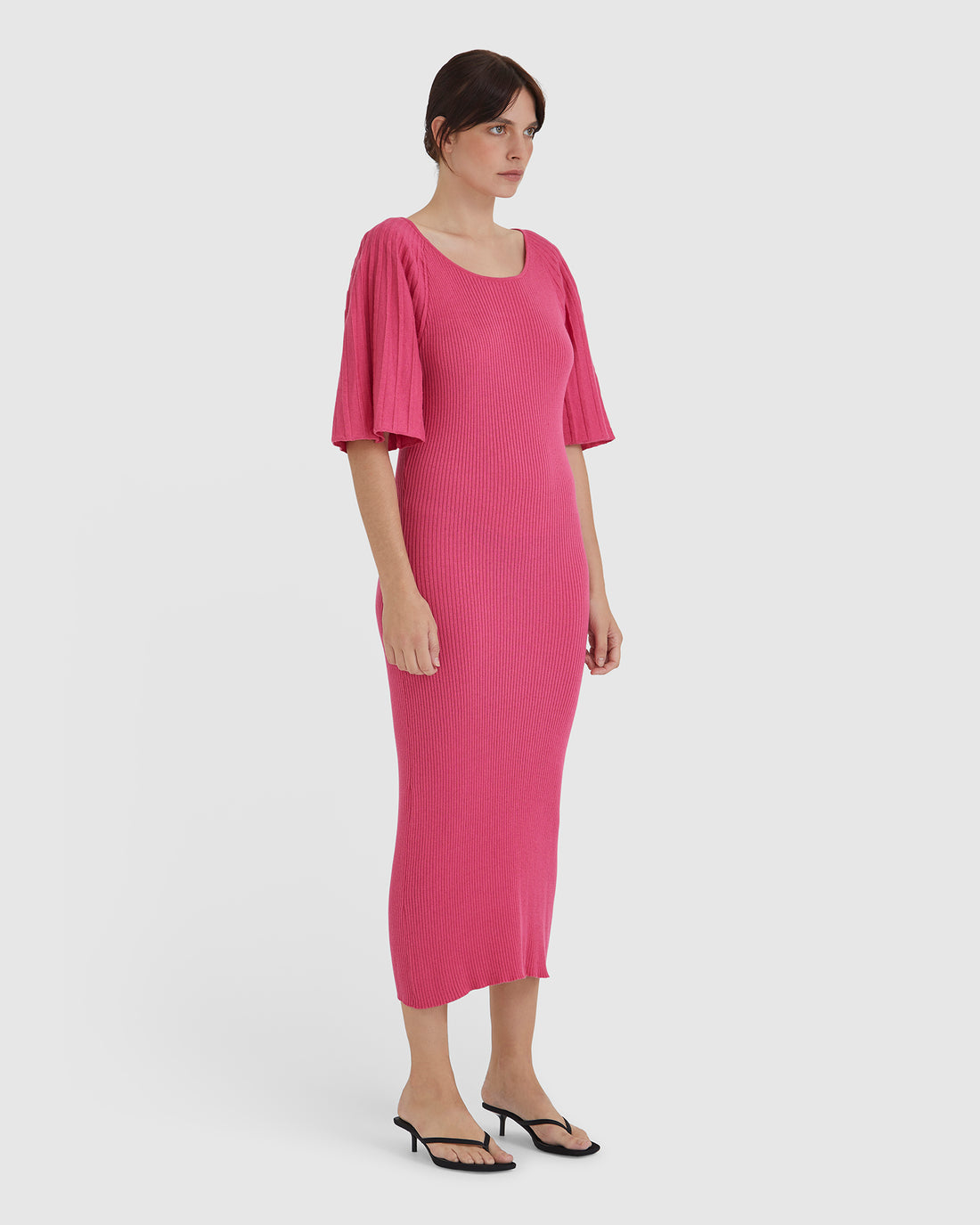 Statement merino wool dress in pomegranate with pleated sleeves.
