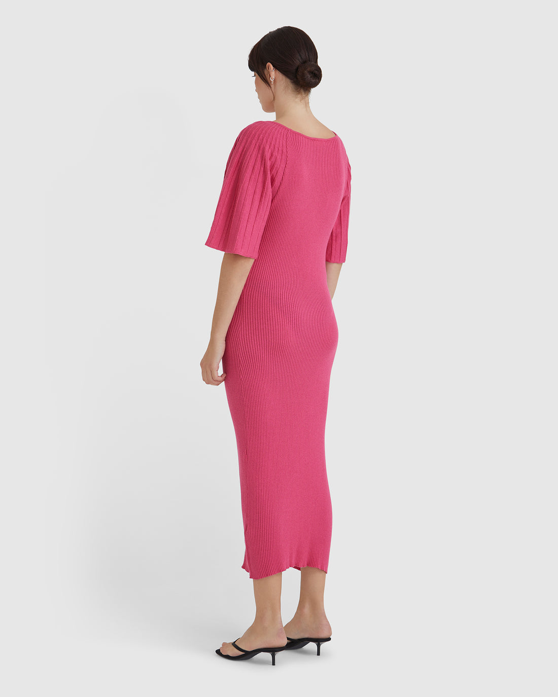 Elegant wool knit dress with pleated sleeves and fitted waist.