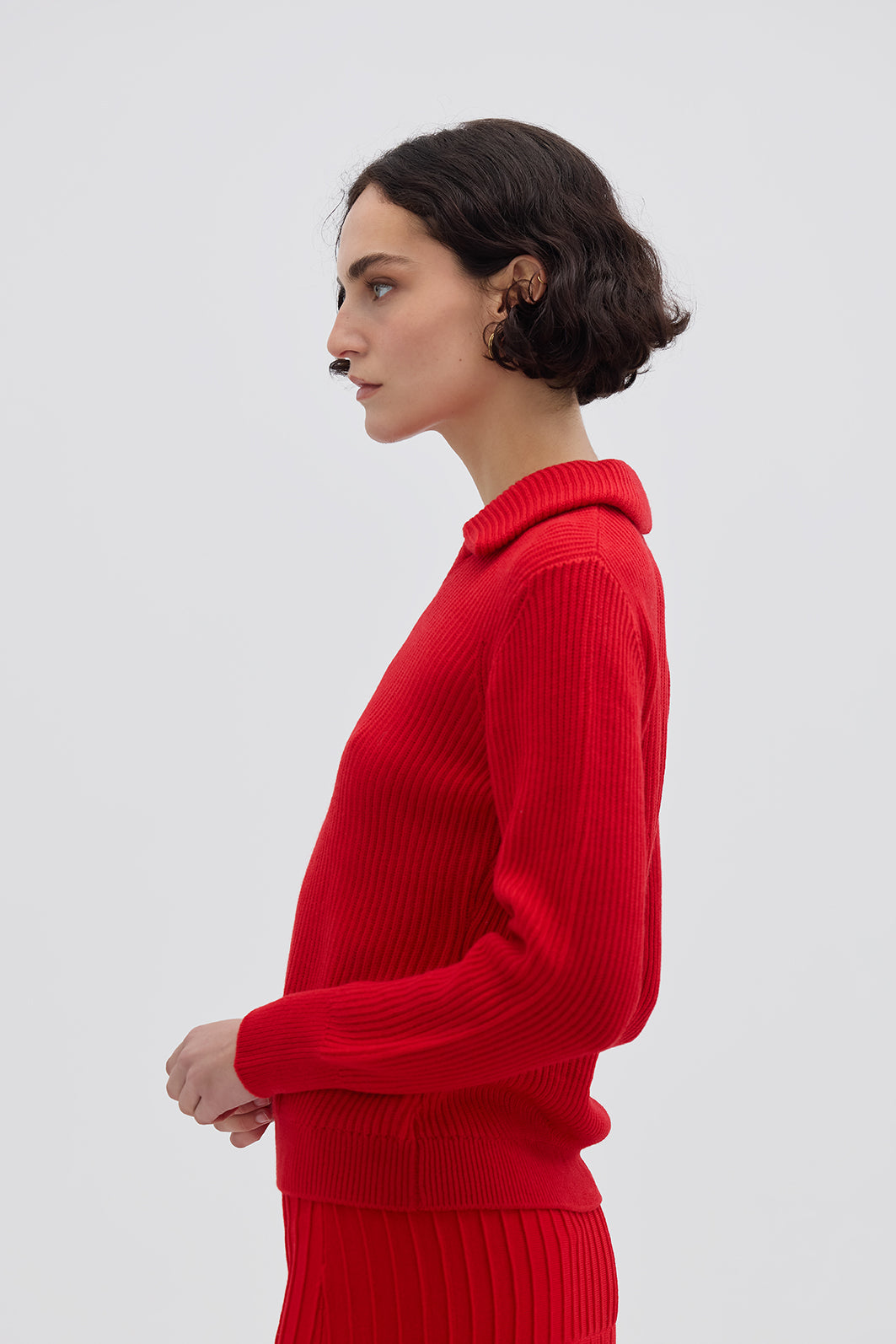 Side profile of model in Red Collar V-Neck Merino Sweater – lightweight and effortlessly chic knitwear