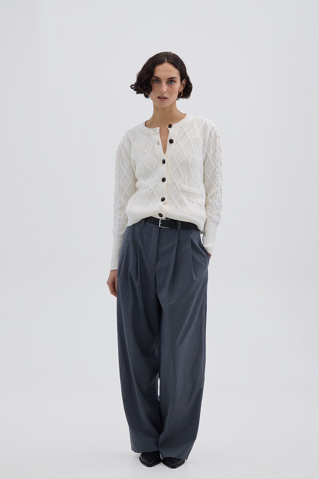 Model wearing the Cream Heart Cable Wool Cardigan – classic ladies wool cardigan with a diamond cable-knit pattern