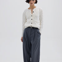 Model wearing the Cream Heart Cable Wool Cardigan – classic ladies wool cardigan with a diamond cable-knit pattern
