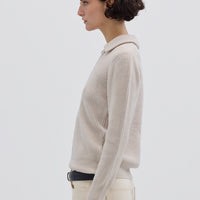Side view of model in Oat Melange Collar V-Neck Merino Sweater – warm and sophisticated knitwear