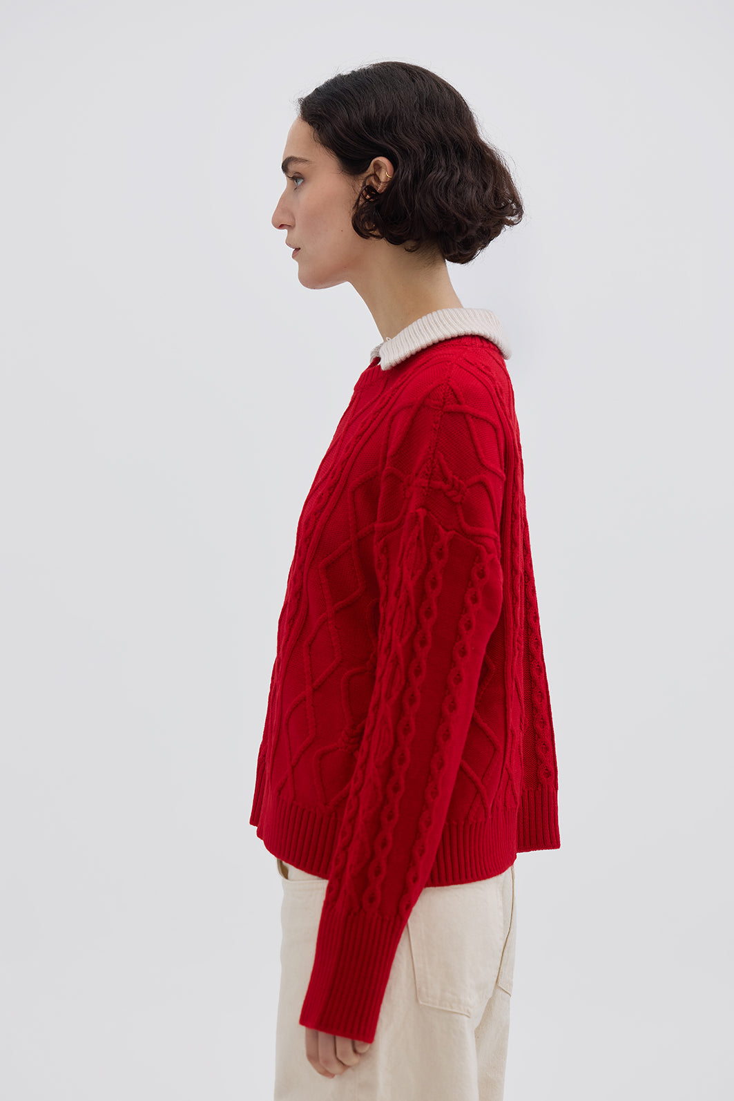 Side profile of model in Red Cable Knit Sweater – warm and effortlessly chic knitwear