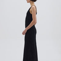 Side profile of model in Black Merino Wool Skirt – sleek silhouette with soft texture
