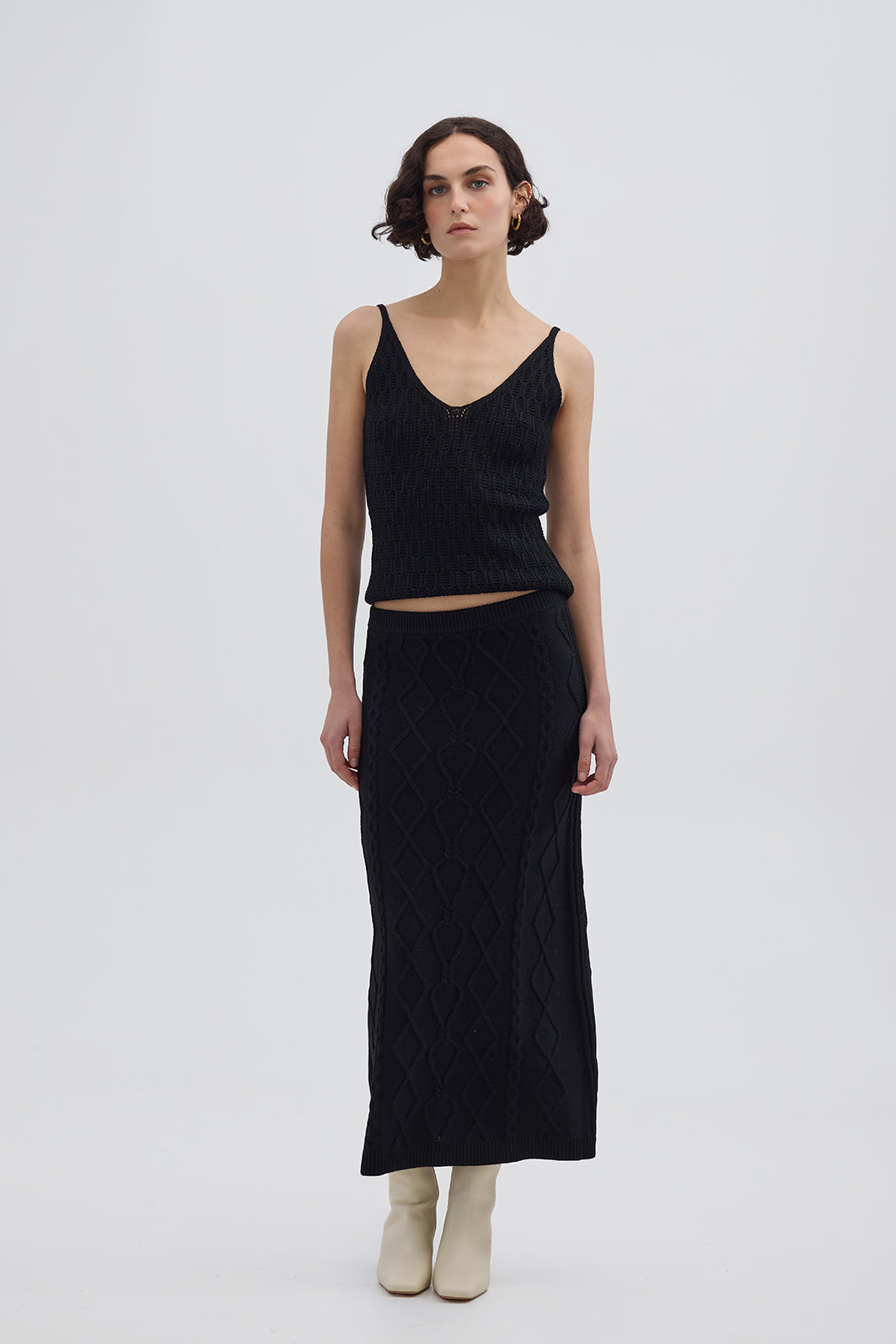 Model wearing the Black Heart Cable Maxi Wool Skirt – elegant and breathable knit skirt