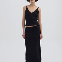 Model wearing the Black Heart Cable Maxi Wool Skirt – elegant and breathable knit skirt