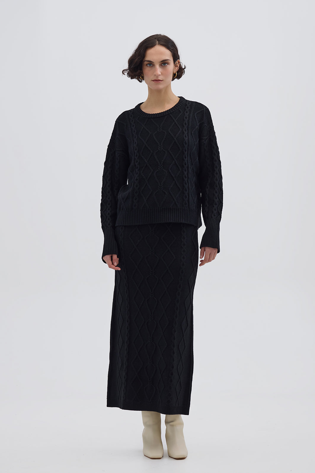 Model wearing the Black Cable Heart Merino Sweater – classic and elegant ladies wool sweater