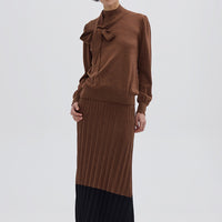 Model wearing the Brown Colour Block Pleat Wool Skirt – sophisticated midi wool skirt with contrast hem
