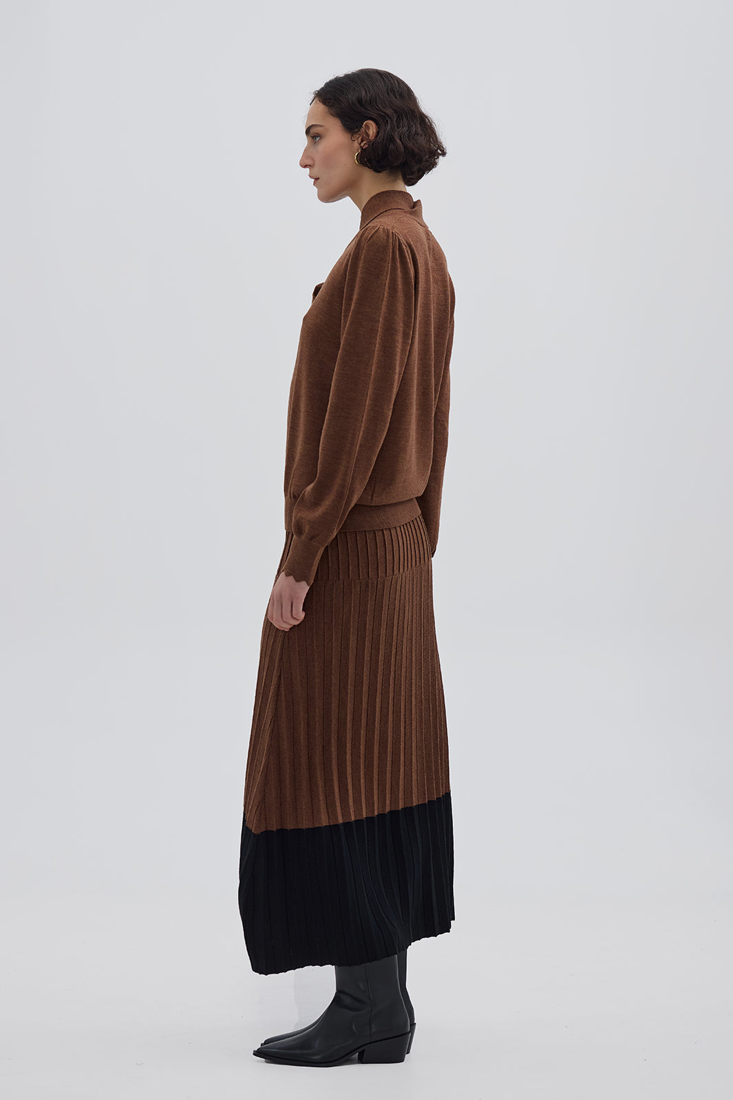 Side profile of model in Brown Wool Skirt – modern contrast detailing with a structured fit