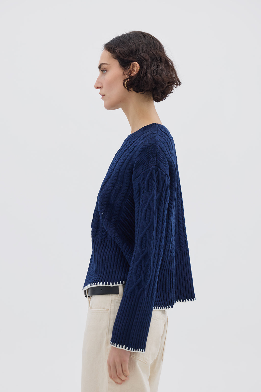 Side profile of model in Burra Crochet Wool Sweater – elegant and warm layering piece