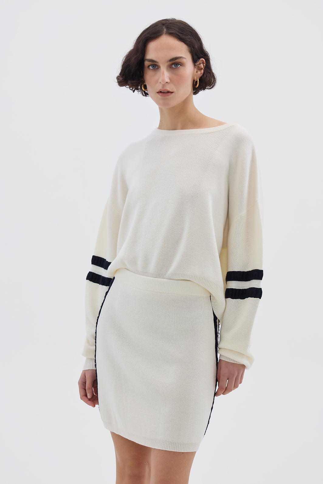 Model wearing the Cream Ruched Striped Rib Merino Sweater – stylish and breathable ladies wool sweater