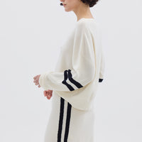 Side profile of model in Cream Striped Wool Sweater – modern, warm, and lightweight knitwear