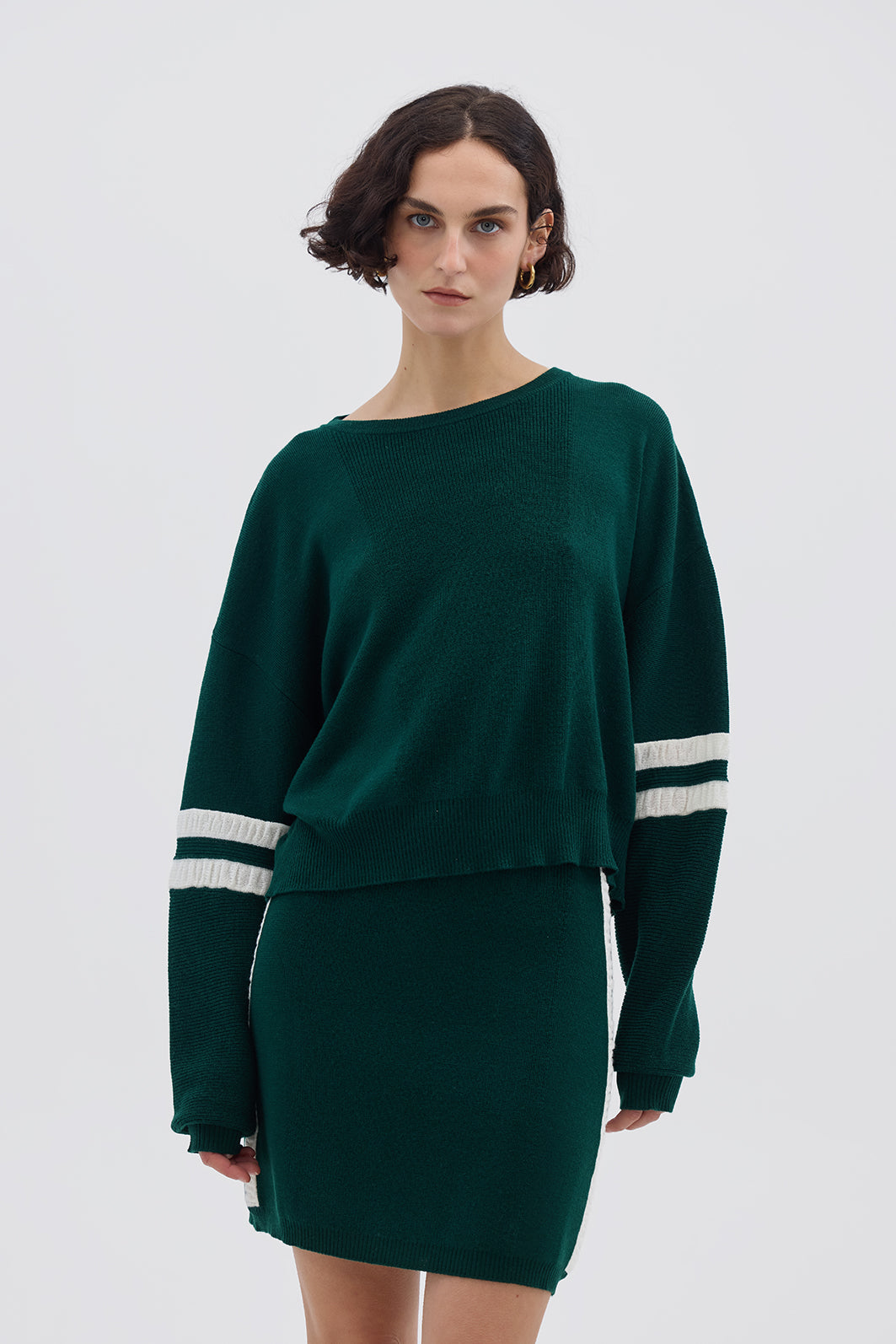 Model wearing the Emerald Ruched Striped Wool Mini Skirt – stylish and breathable Merino wool skirt