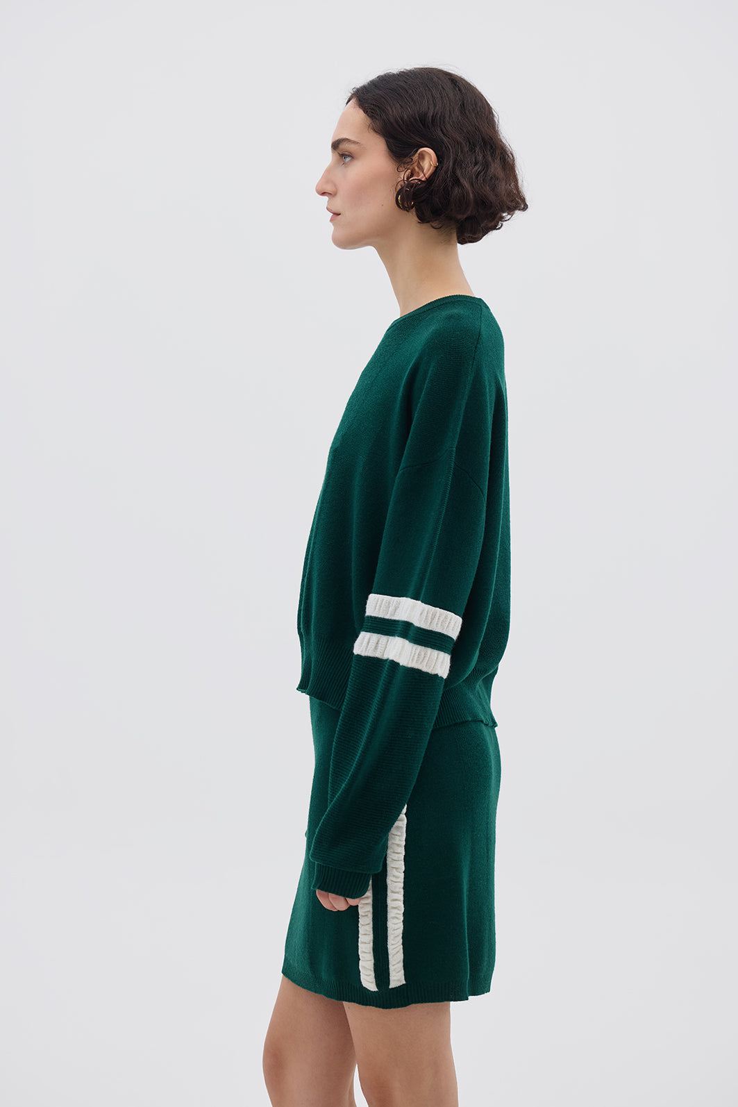 Side profile of model in Emerald Striped Wool Sweater – stylish, lightweight, and warm layering piece