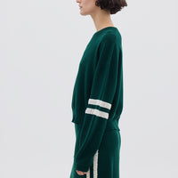 Side profile of model in Emerald Striped Wool Sweater – stylish, lightweight, and warm layering piece