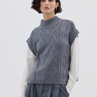 Model wearing Knitted Vest Grey – elegant sleeveless ladies wool vest with heart cable-knit detail