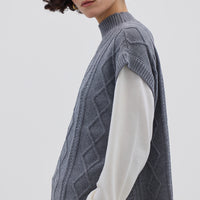 Side view of model in Grey Knitted Vest – lightweight, warm Merino wool layering piece