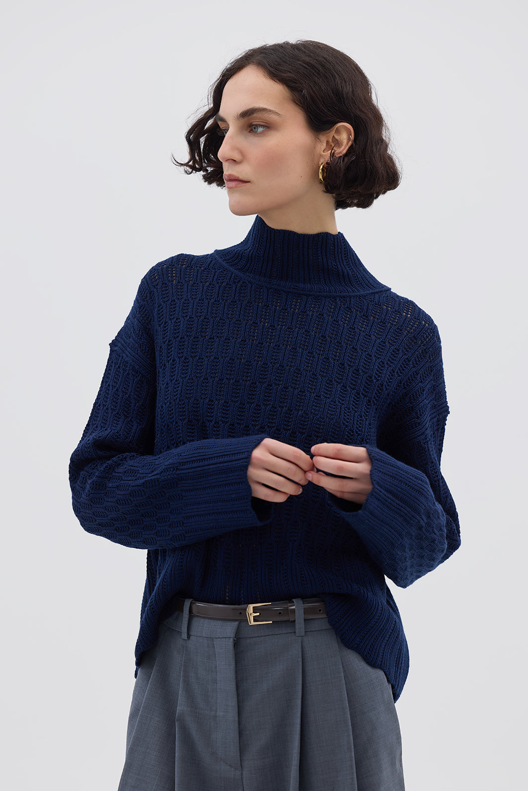 Model wearing the Navy Corded Rib High Neck Merino Sweater – stylish and breathable ladies wool sweater