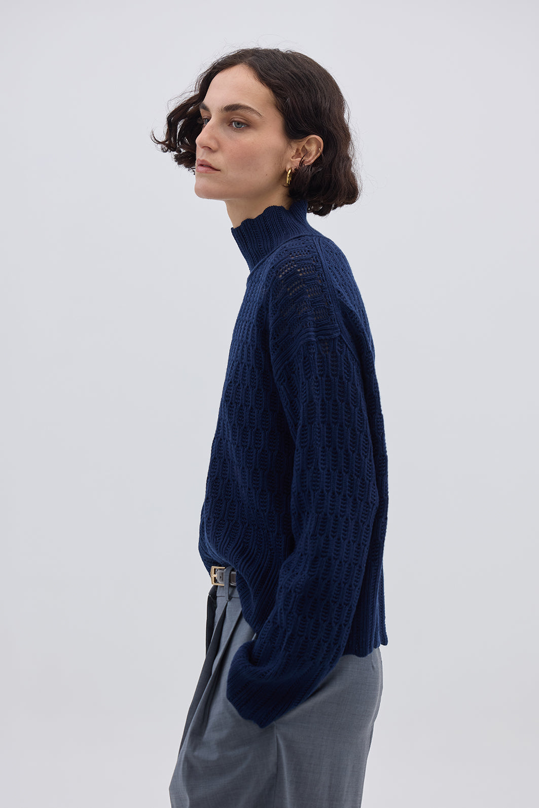 Side profile of model in Navy High Neck Wool Sweater – soft, warm, and refined layering piece