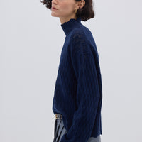 Side profile of model in Navy High Neck Wool Sweater – soft, warm, and refined layering piece