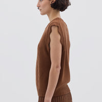 Side profile of model in Walnut Wool Vest – classic sleeveless design with a timeless crew neckline