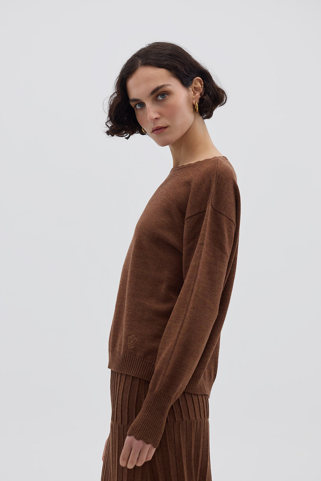 Side profile of model in Core Merino Wool Sweater – timeless and versatile ladies knitwear