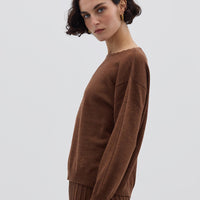 Side profile of model in Core Merino Wool Sweater – timeless and versatile ladies knitwear