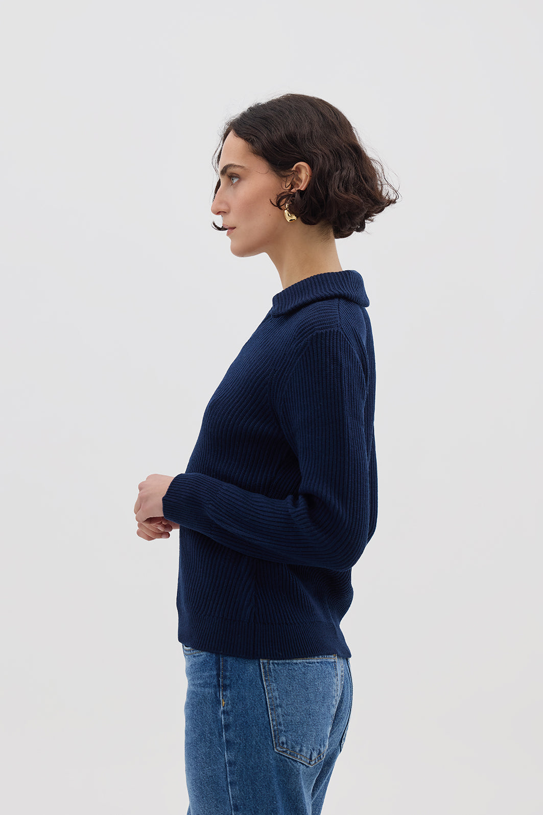 Side profile of model in Navy Collar V-Neck Merino Sweater – elegant and warm wool knitwear