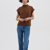 Model wearing Cable Vest Brown – classic sleeveless ladies wool vest with intricate knit detailing