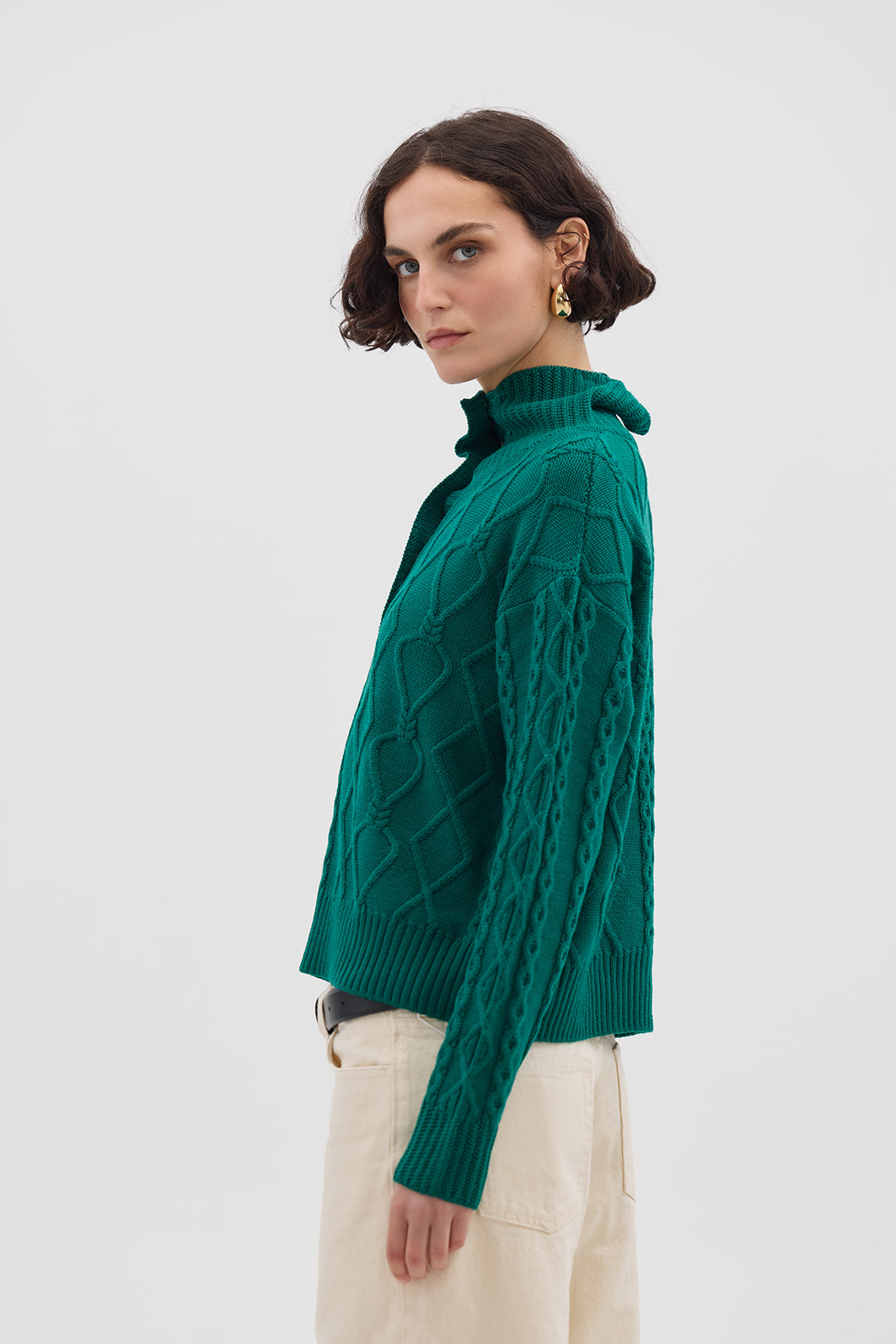 Side profile of model in Emerald Button-Neck Wool Sweater – effortlessly elegant and cozy knitwear