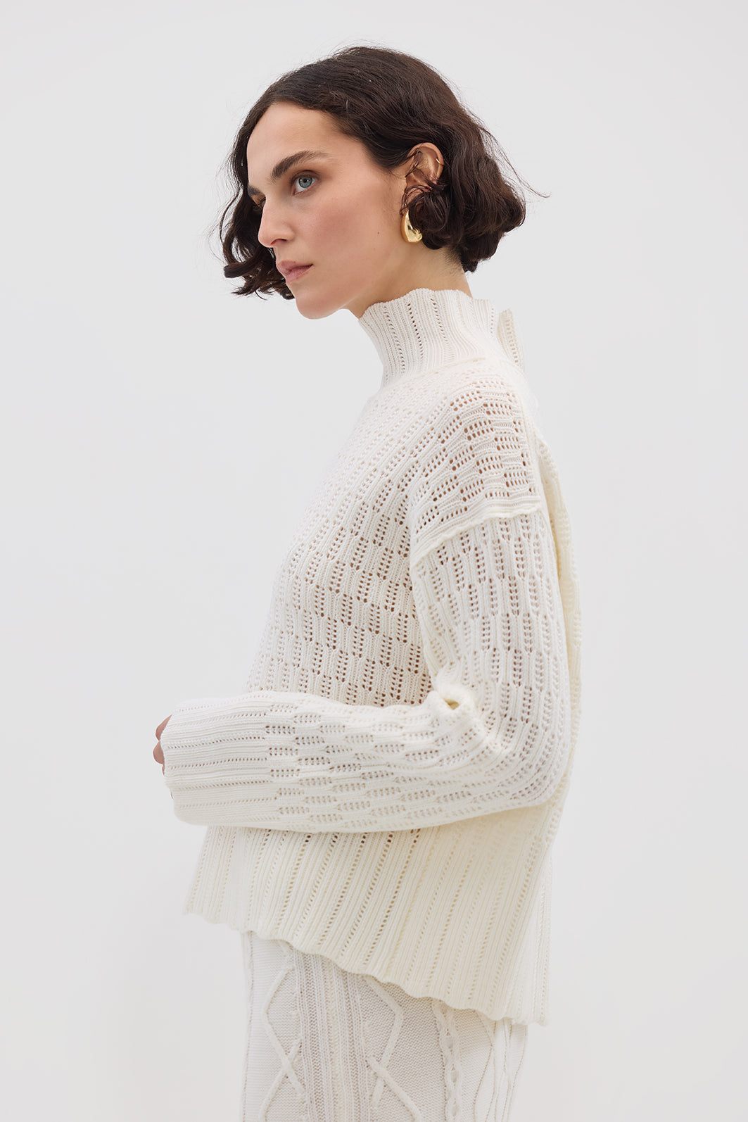 Side profile of model in Cream High Neck Wool Sweater – cozy, elegant, and effortlessly stylish