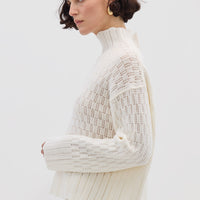 Side profile of model in Cream High Neck Wool Sweater – cozy, elegant, and effortlessly stylish